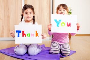 Kids holding thank you signs