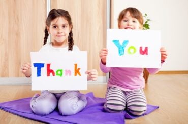 5 games to help kids learn the true meaning of gratitude Kids holding thank you signs