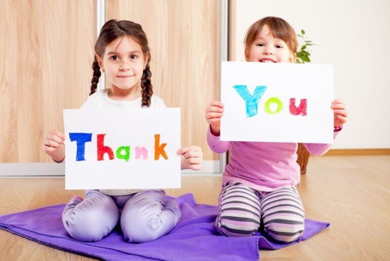 Kids holding thank you signs