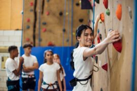 Teen at indoor climbing wall