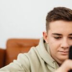 Teen boy engrossed in smartphone