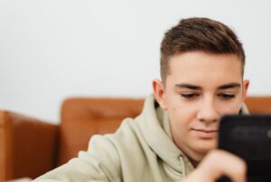 Teen boy engrossed in smartphone