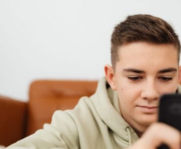 Teen boy engrossed in smartphone
