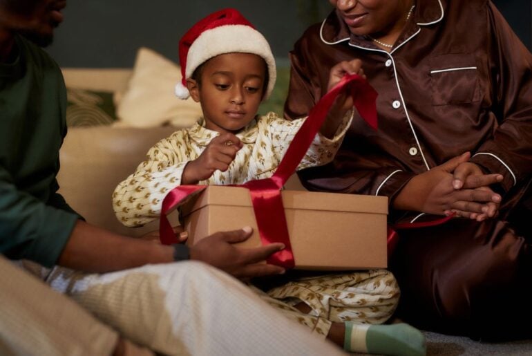 What to do if your kids get unwelcome tech gifts this holiday season Kid unwrapping gift