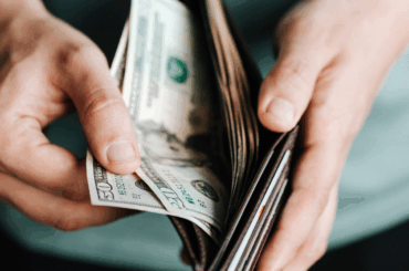 Investigation finds school voucher families misused education funds Money in an open wallet