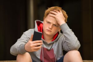 Teen boy looking at cellphone