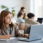 Student using laptop in classroom