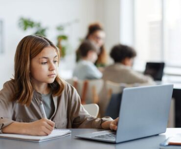 Student using laptop in classroom