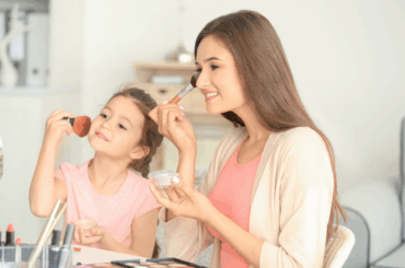Mom and daughter putting on makeup