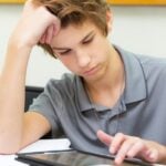 Teen student uses a tablet device in the classroom
