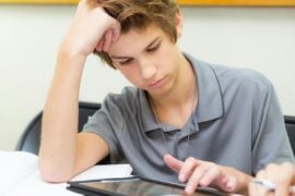 Teen student uses a tablet device in the classroom