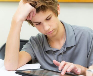 Teen student uses a tablet device in the classroom