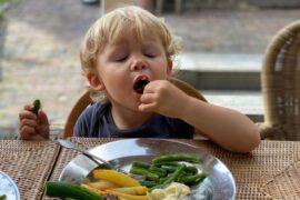 Toddler eating vegetables