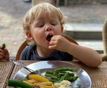 Toddler eating vegetables