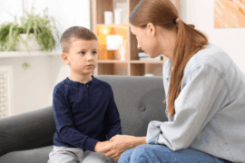 A mom holds her young child's hand and makes amends