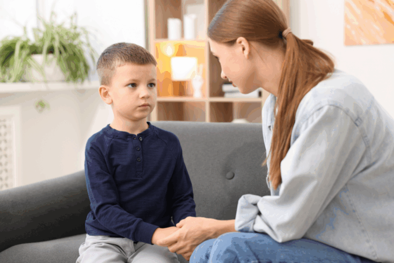 A mom holds her young child's hand and makes amends
