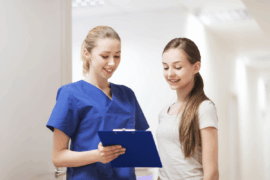 Nurse and teen talking during an exam