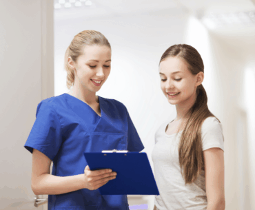 Nurse and teen talking during an exam