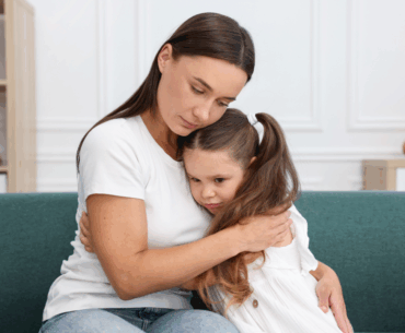Mom hugging a sad child