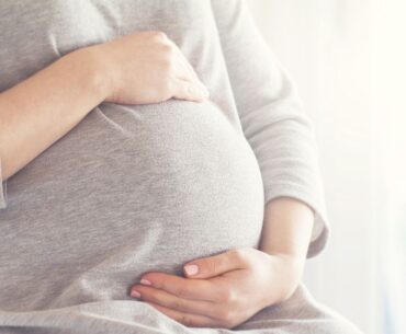 Pregnant mom cradling belly