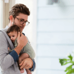 Dad holding newborn baby