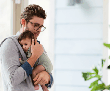 Dad holding newborn baby
