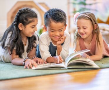 Kids reading together on rug