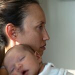 Sad lonely mother with newborn