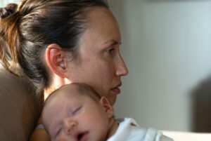 Sad lonely mother with newborn
