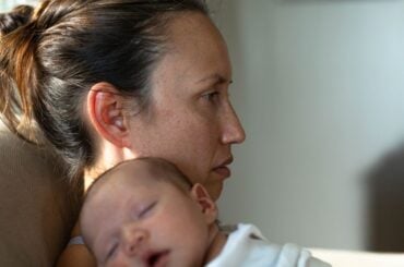 Trapped and alone: Fear of ICE is deepening postpartum isolation for immigrant mothers Sad lonely mother with newborn