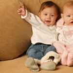 Boy and girl babies sitting together