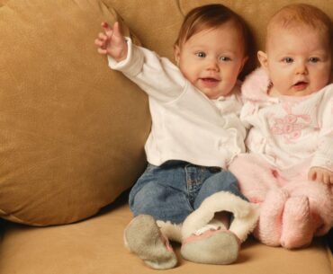 Boy and girl babies sitting together