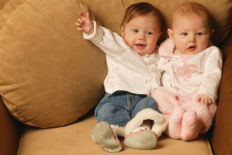 Boy and girl babies sitting together