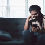 Sad teen sitting on couch