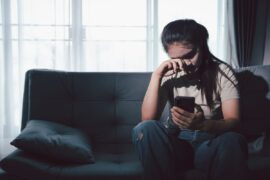 Sad teen sitting on couch