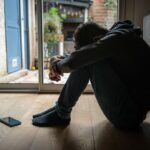 Distressed teenager with head down