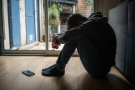Distressed teenager with head down