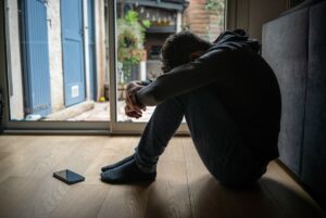 Distressed teenager with head down