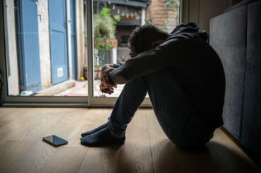 Distressed teenager with head down