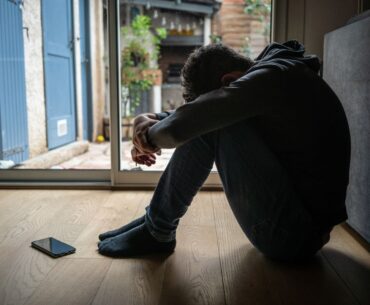 Distressed teenager with head down