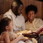 Dad reading book to kids