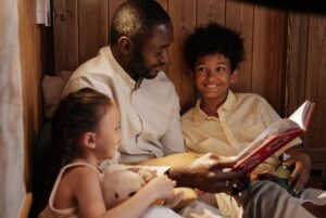 Dad reading book to kids