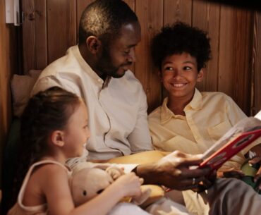 Dad reading book to kids