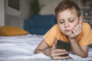 Kid staring at smartphone