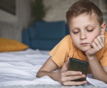 Kid staring at smartphone