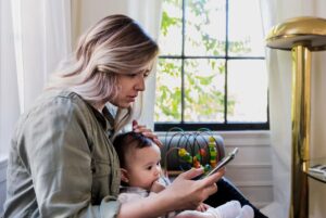 Worried mom consulting phone for answers