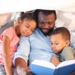 Black dad reading to kids
