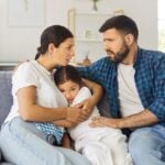 Parents hugging child during crisis