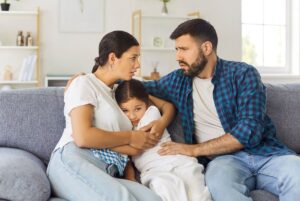 Parents hugging child during crisis