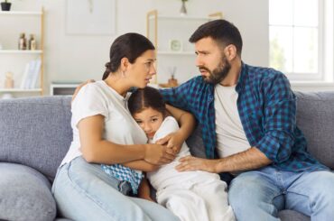 Everyone experiences loss and grief – but that doesn’t make it any easier to talk with kids about it Parents hugging child during crisis